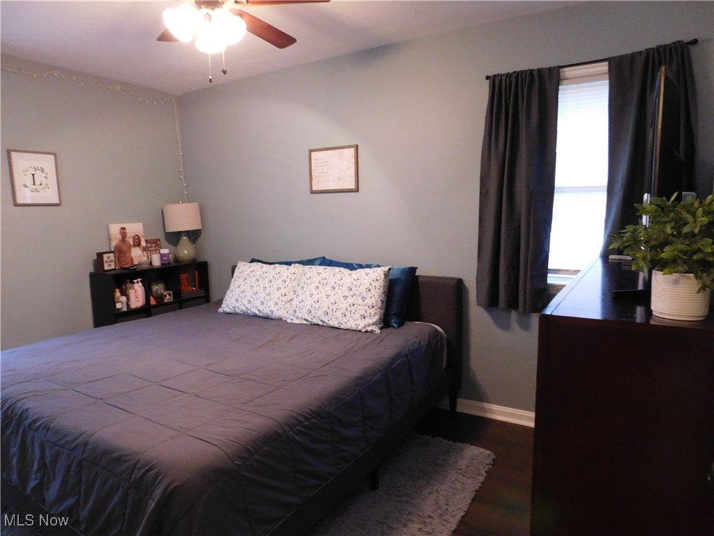 9720 West Ridgewood Drive Parma Heights, OH 44130 - Photo 20 of 46 Bedroom featuring a ceiling fan, wood finished floors, and baseboards