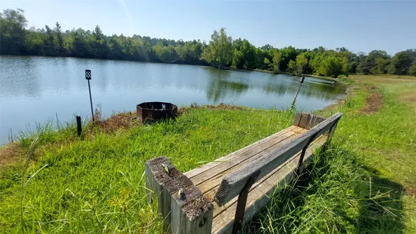 a backyard of a house with lots of green space and lake view