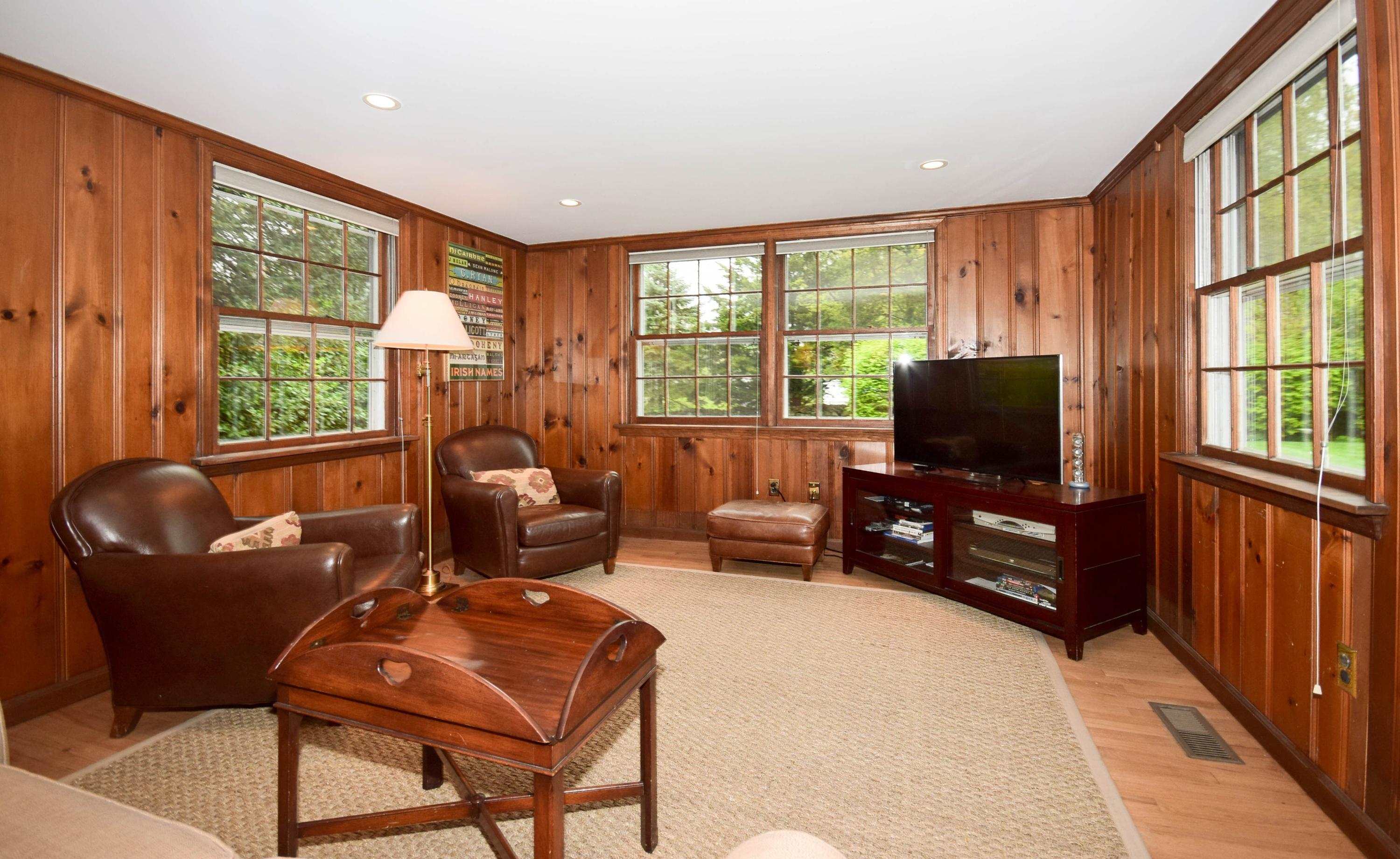 21 Wilson Ridge Road Darien, CT 06820 - Photo 8 of 17 a living room with furniture a flat screen tv and a floor to ceiling window