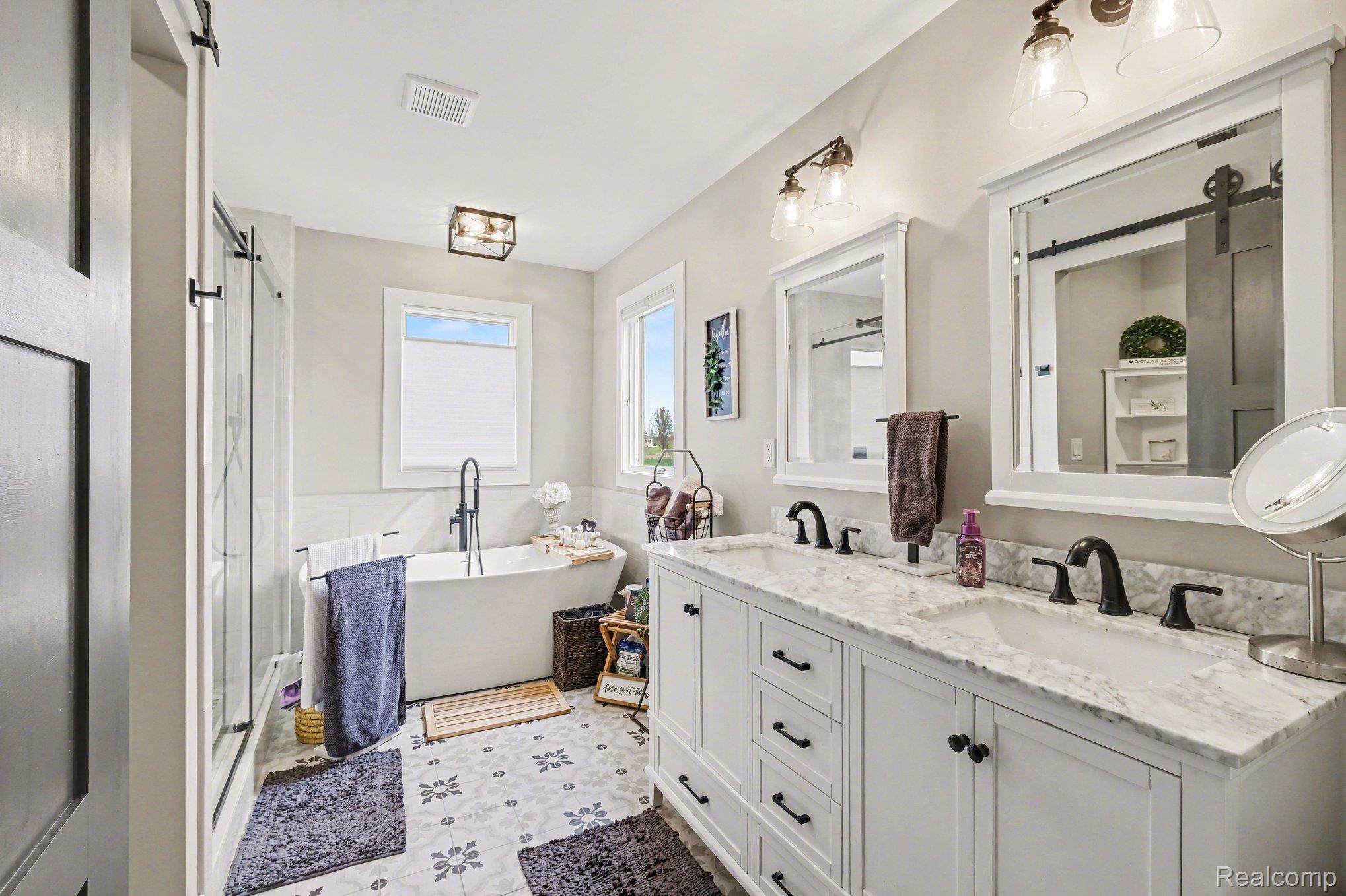 9084 Copper Ridge Drive Davison, MI 48423 - Photo 23 of 42 Bathroom featuring double vanity, a soaking tub, and a shower stall