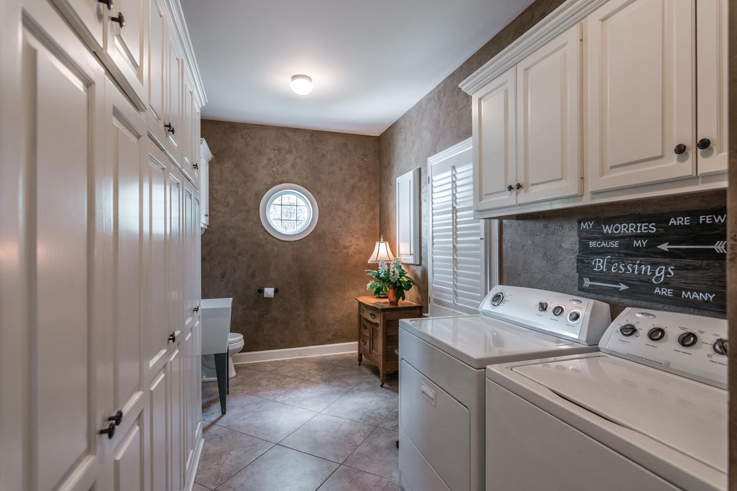 1012 Franklin Road Gallatin, TN 37066 - Photo 22 of 30 a view of washer and dryer with bathroom in the background