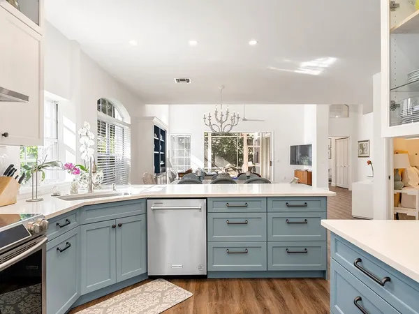 a kitchen with a sink stove and cabinets