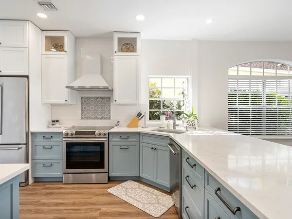a kitchen with stainless steel appliances granite countertop a sink stove and refrigerator
