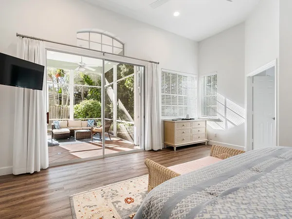 a bedroom with furniture and large windows