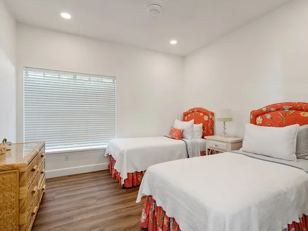 a bedroom with two beds and a window