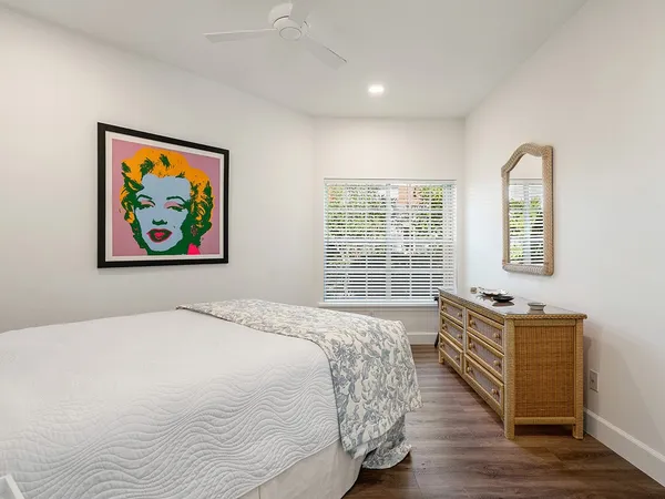 a spacious bedroom with a bed and a window