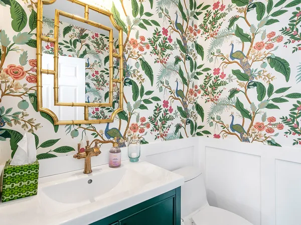 a bathroom with a sink and mirror with toilet