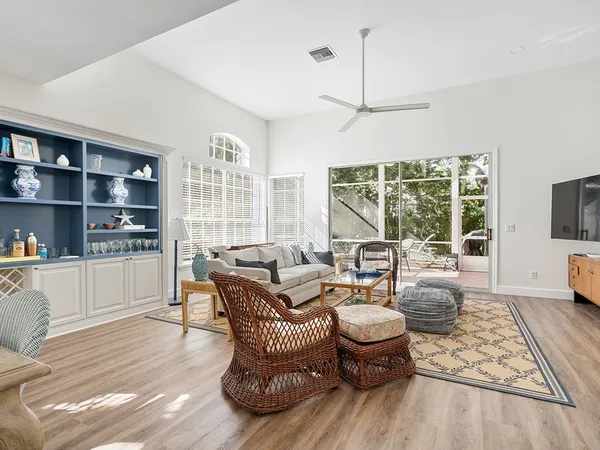 a living room with furniture and a floor to ceiling window