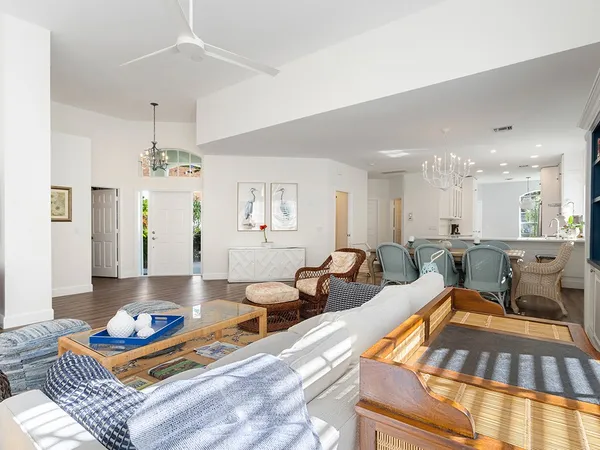 a living room with lots of furniture and kitchen view
