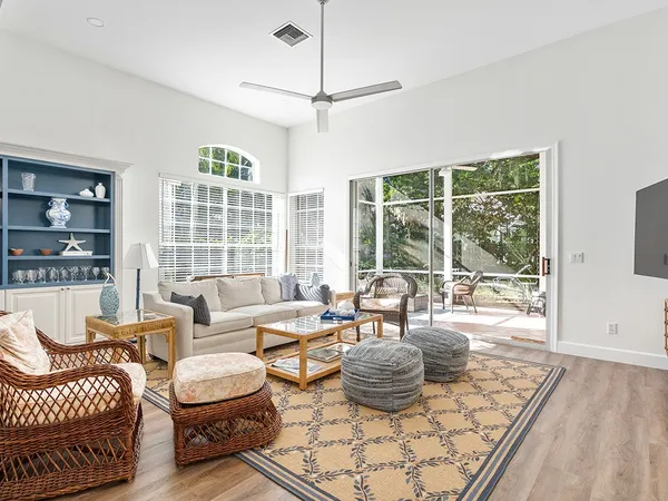 a living room with furniture and a floor to ceiling window