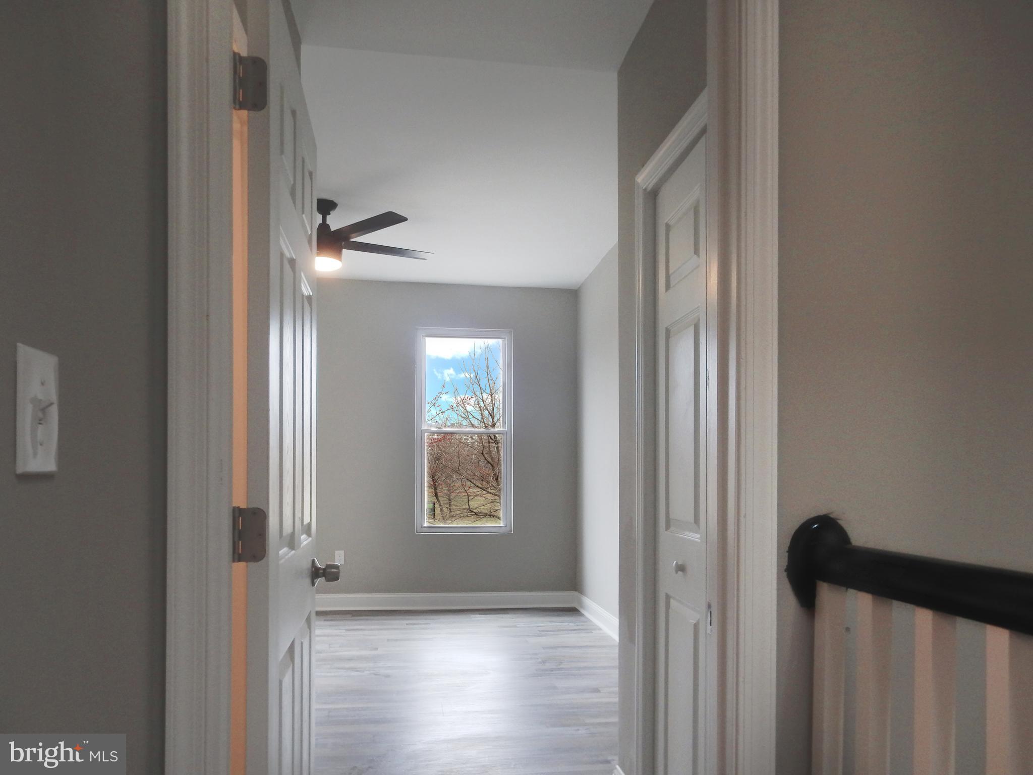 1111 Bayard Street Baltimore, MD 21223 - Photo 16 of 41 a view of hallway with windows and wooden floor