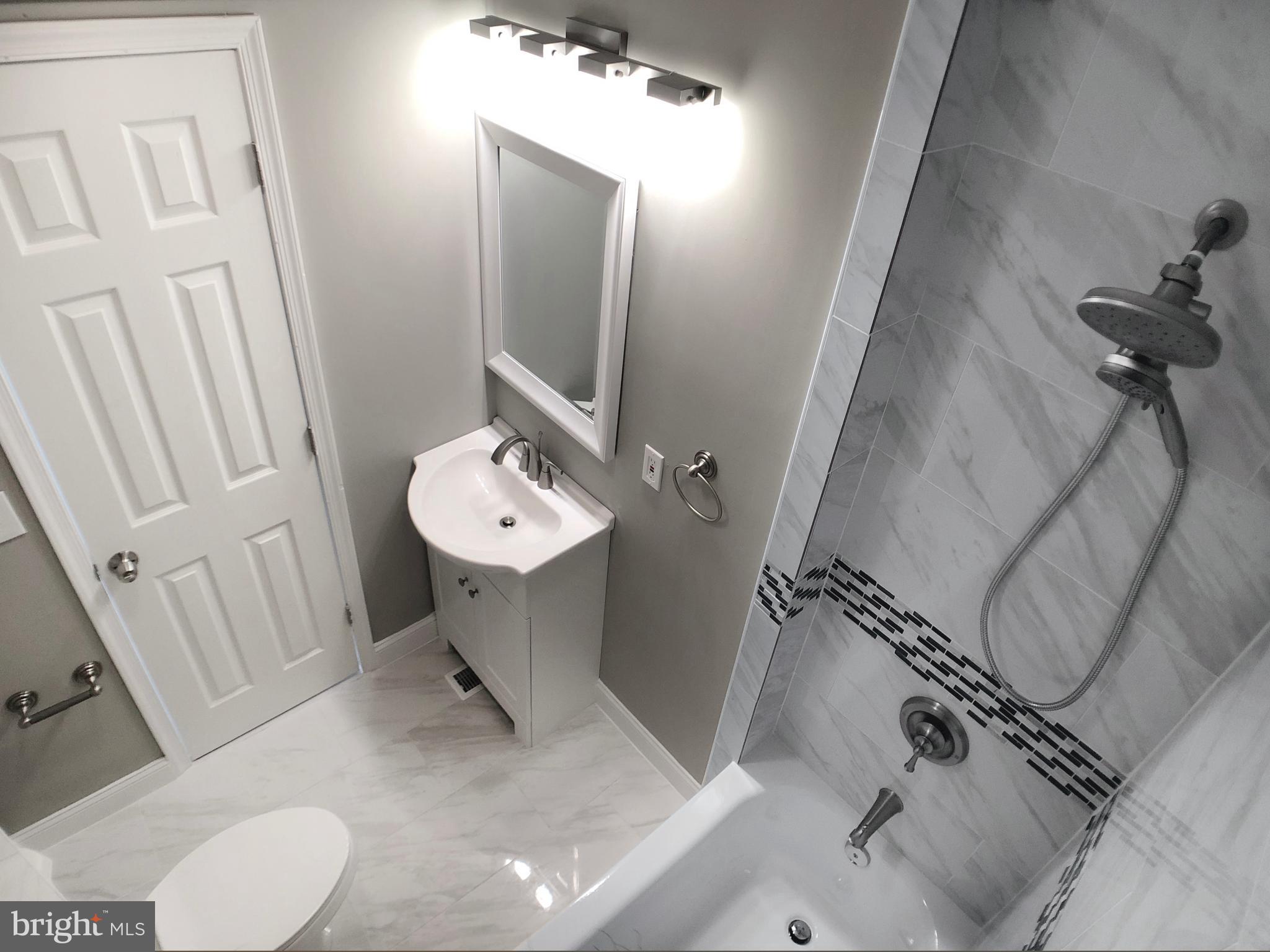 1111 Bayard Street Baltimore, MD 21223 - Photo 22 of 41 a bathroom with a sink a toilet and mirror