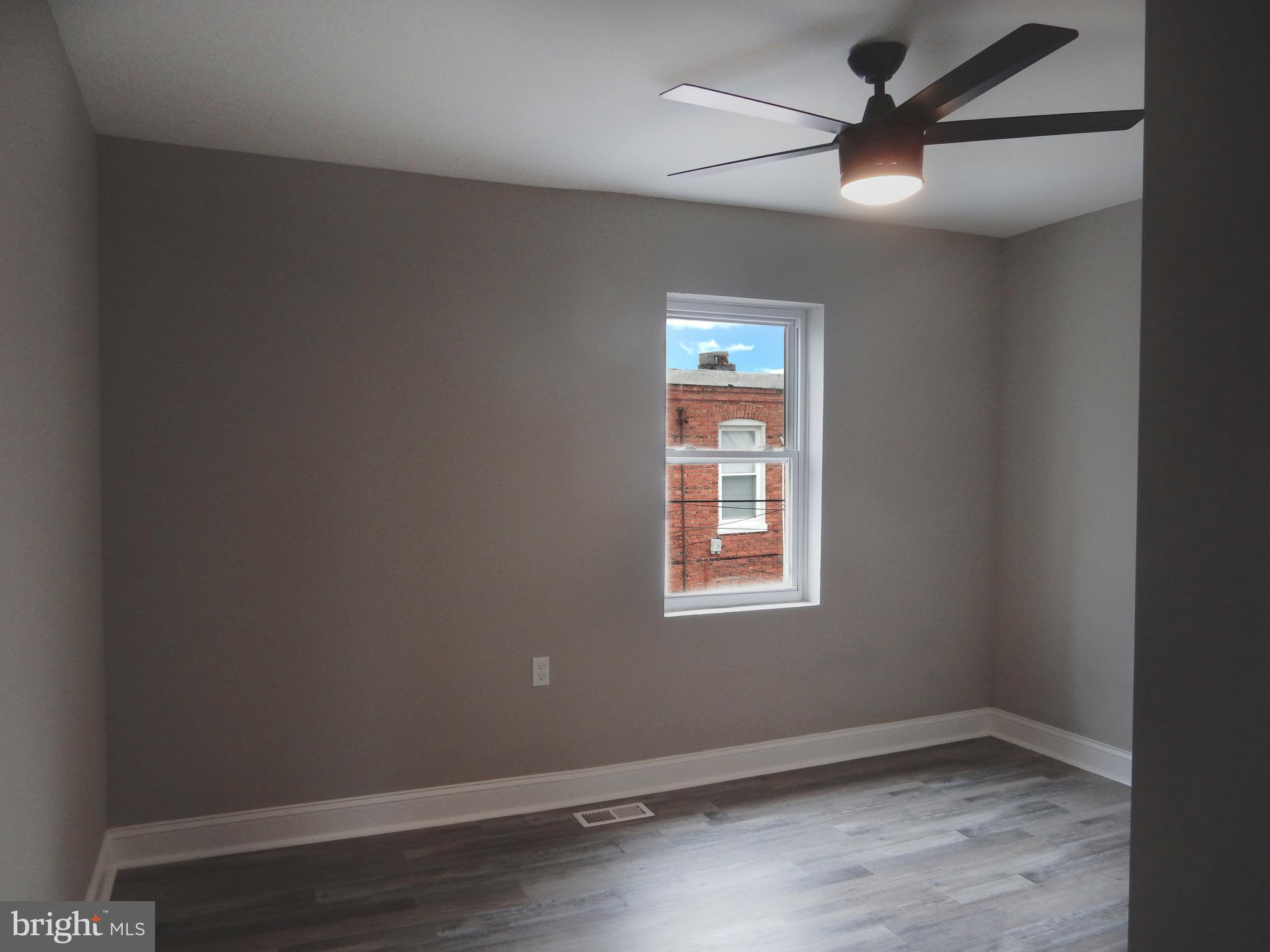 1111 Bayard Street Baltimore, MD 21223 - Photo 24 of 41 an empty room with a window and a fan