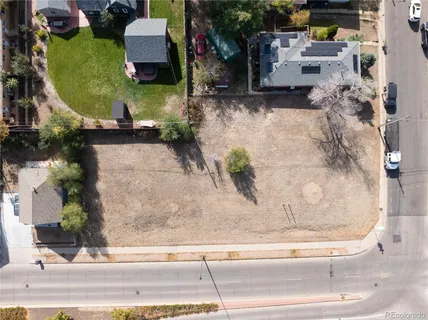 an aerial view of a house with a yard and sitting area
