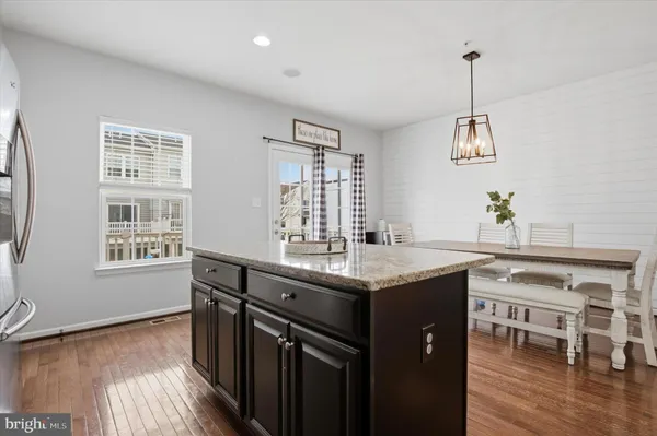 a kitchen with a center island wooden floor and a window