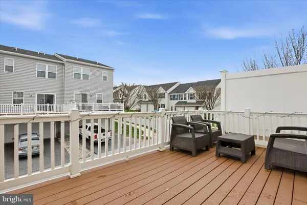 a view of a balcony with furniture and wooden floor