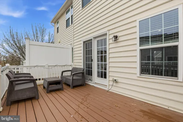 a view of a deck with couches floor to ceiling window with wooden floor