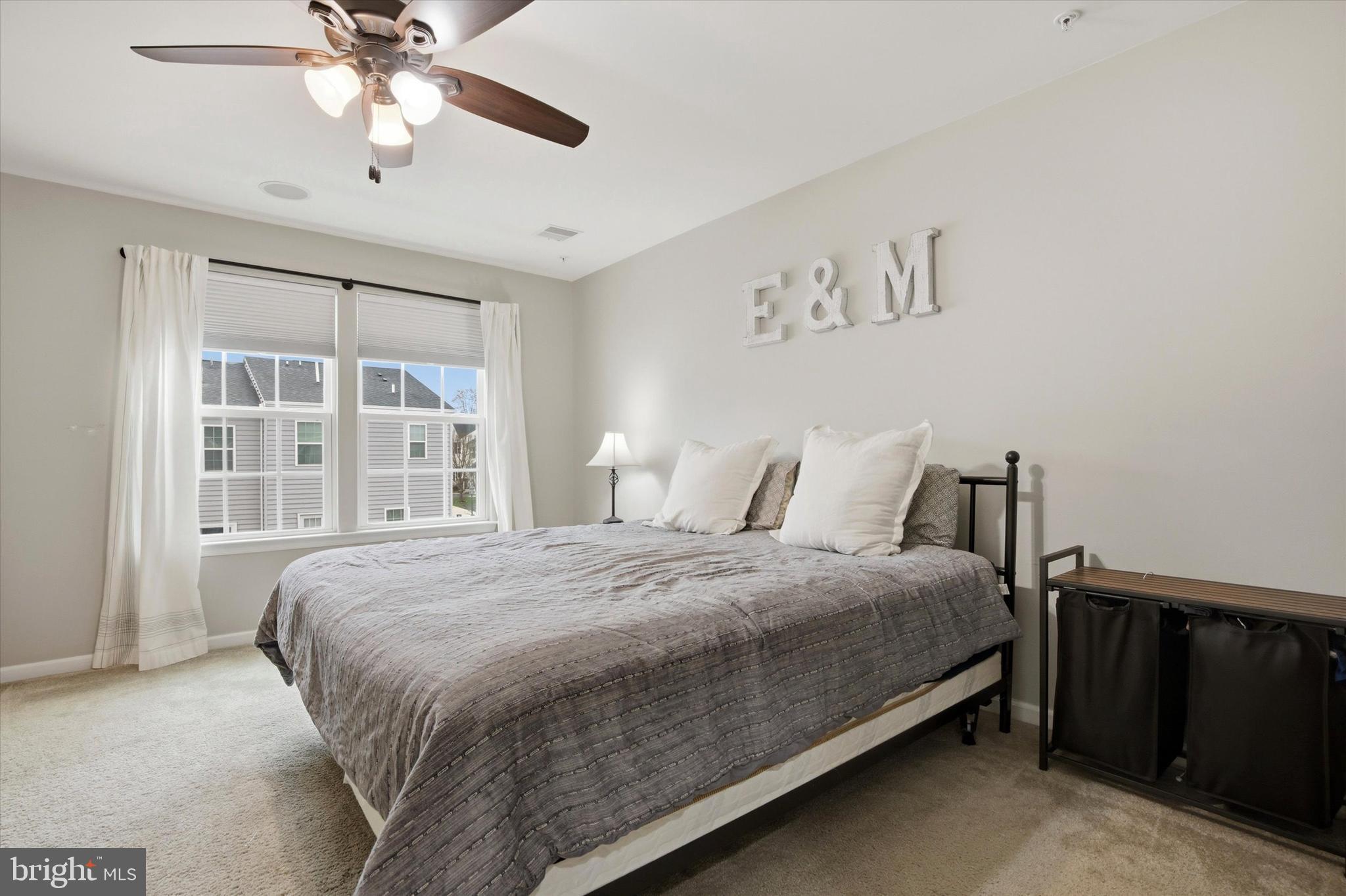 422 Lopata Road Phoenixville, PA 19460 - Photo 24 of 35 a bedroom with a large bed and a chandelier fan