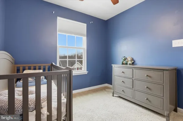 a bedroom with a bunk bed and a window