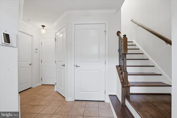 a view of entryway with wooden floor and stairs