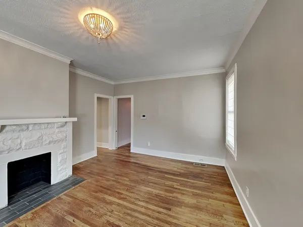 wooden floor in an empty room with a fireplace