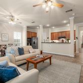 a living room with furniture and kitchen view