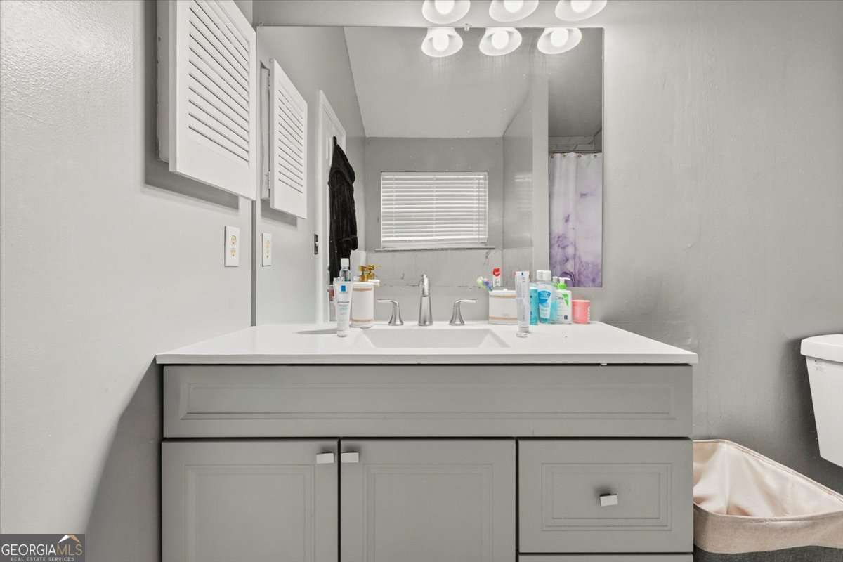 1362 Tara Road Jonesboro, GA 30238 - Photo 17 of 30 a bathroom with a sink and a mirror