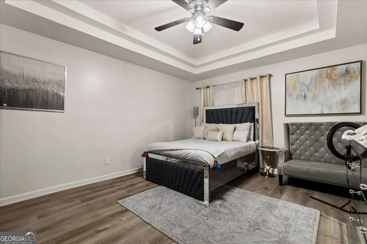 1362 Tara Road Jonesboro, GA 30238 - Photo 21 of 30 a bedroom with a bed and wooden floor