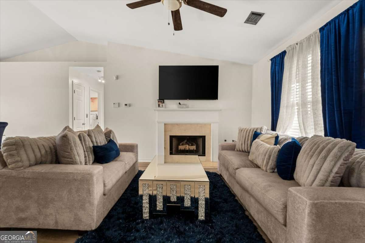 1362 Tara Road Jonesboro, GA 30238 - Photo 7 of 30 a living room with furniture fireplace and flat screen tv