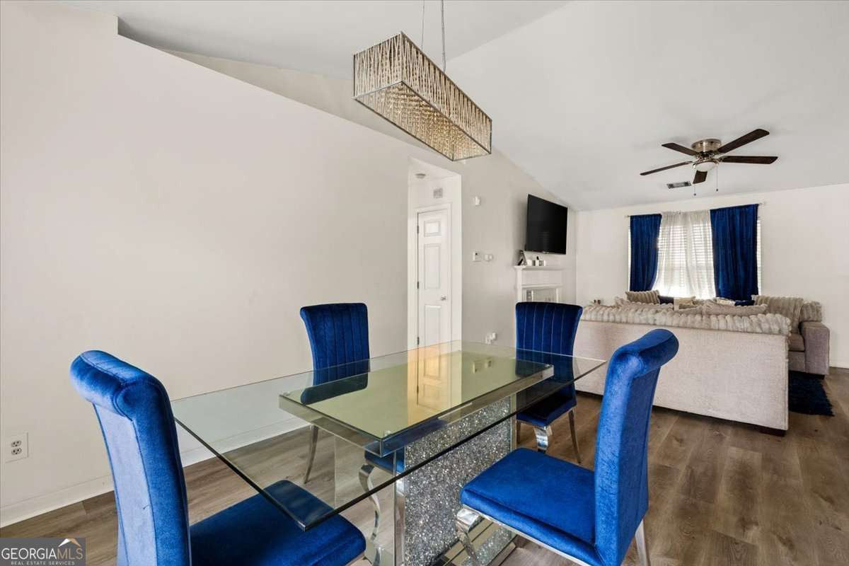 1362 Tara Road Jonesboro, GA 30238 - Photo 8 of 30 a living room with furniture a fireplace and a flat screen tv