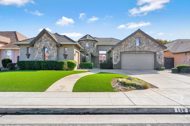 a front view of a house with garage and garage
