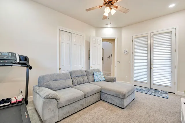 a living room with furniture and a chandelier