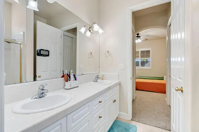 a bathroom with a double vanity sink and a mirror