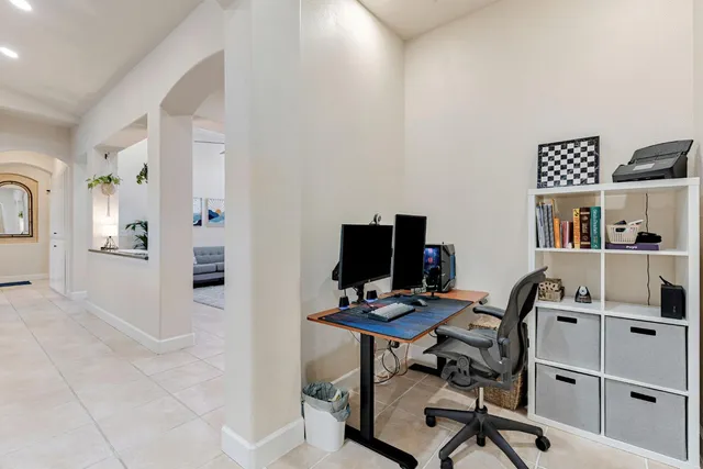 a view of a workspace with furniture and a window