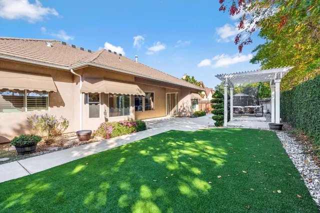 a view of a house with backyard porch and sitting area