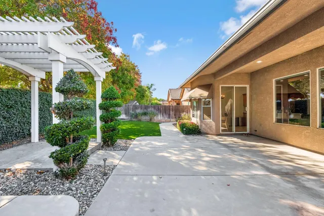 a view of a house with backyard porch and garden