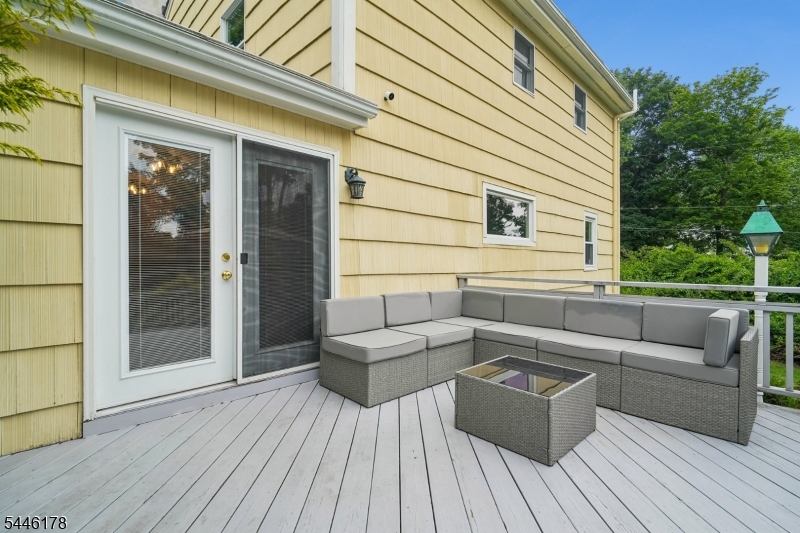361 North Road Chester, NJ 07930 - Photo 14 of 17 a view of a patio with couches and a potted plant on a wooden floor
