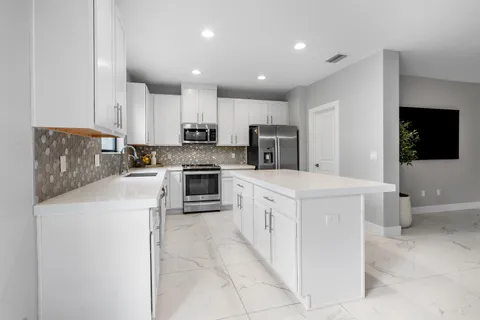 a kitchen with cabinets and white appliances