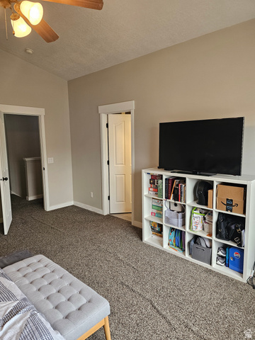 7481 Red Pine Road Eagle Mountain, UT 84005 - Photo 22 of 38 Master bedroom carpeted room with a ceiling fan featuring integrated lighting, two white panel doors, and a built-in shelving unit