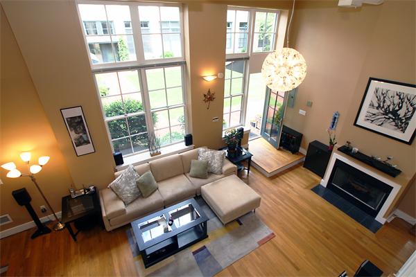 a living room with furniture wooden floor and a large window