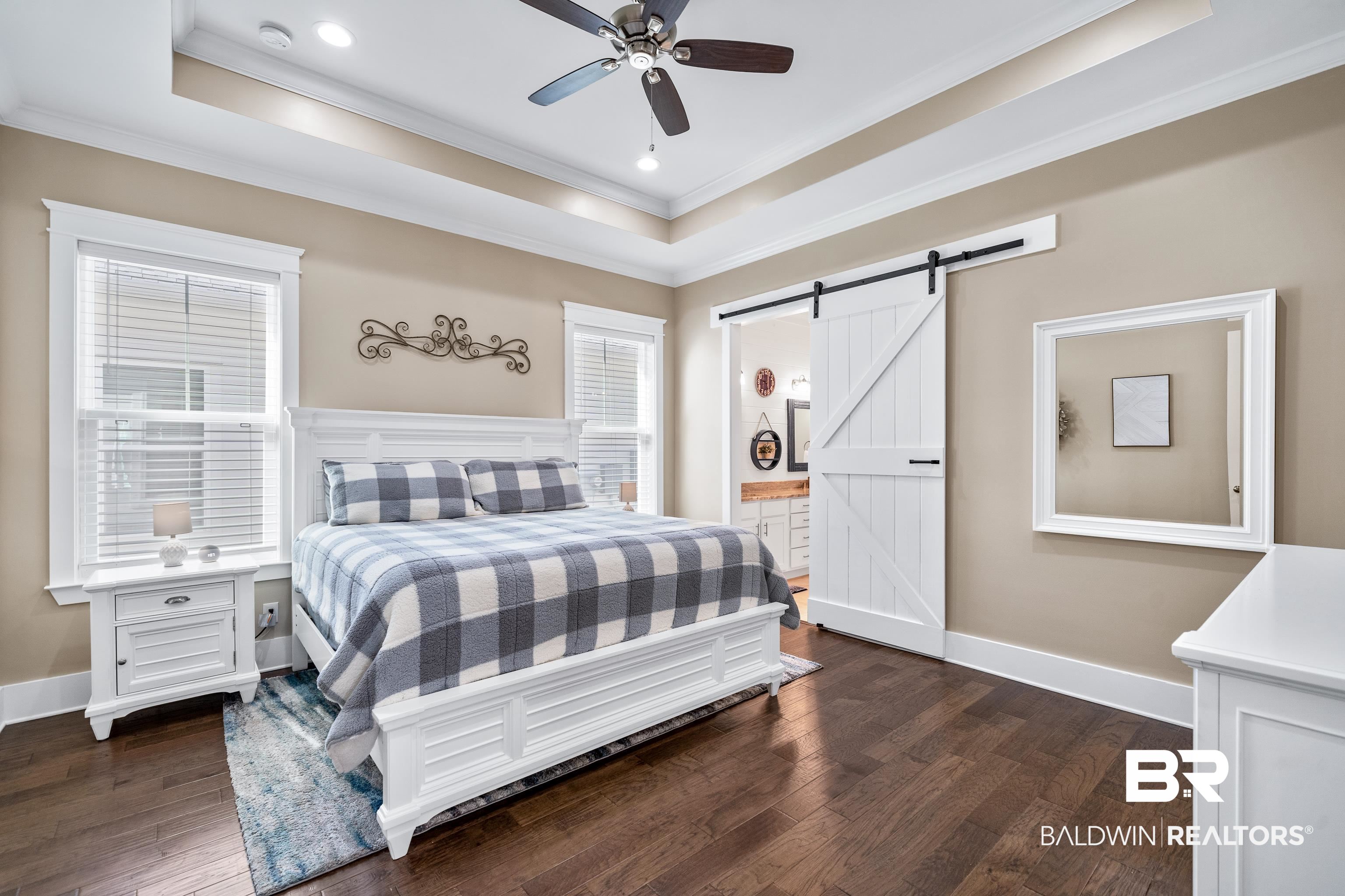 1018 Snapdragon Lane Foley, AL 36535 - Photo 21 of 37 Bedroom featuring a raised ceiling, a barn door, ceiling fan, and dark hardwood / wood-style flooring