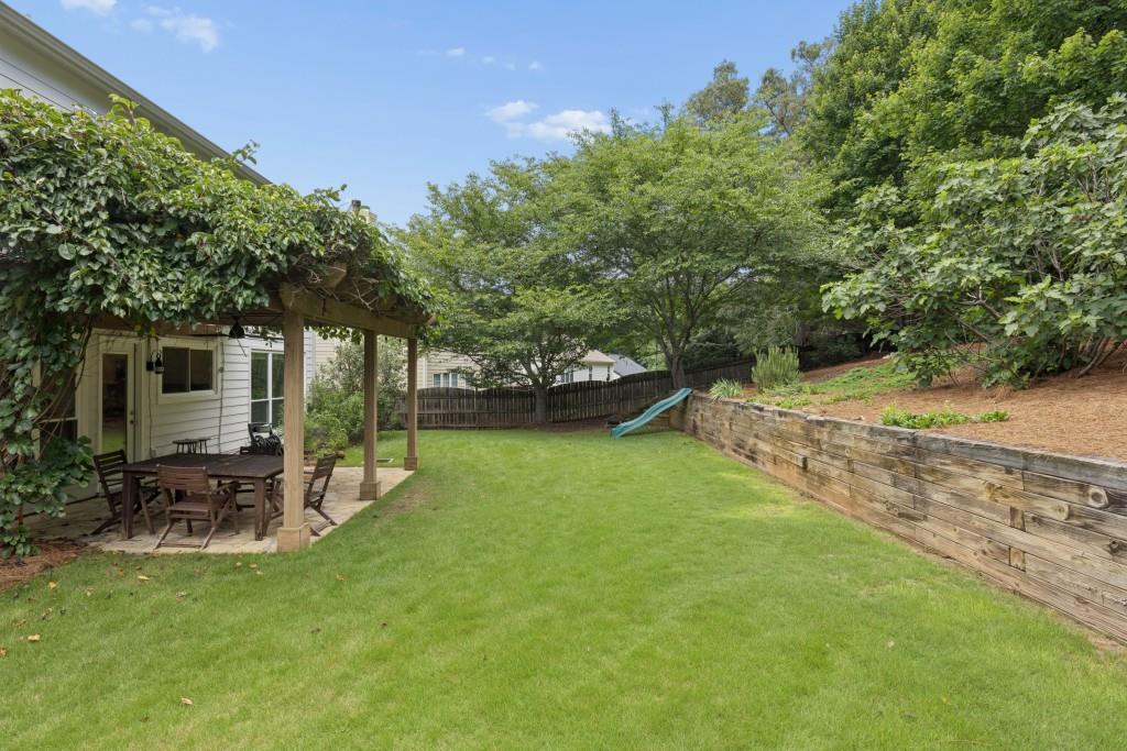 2120 Traywick Chase Alpharetta, GA 30004 - Photo 50 of 54 a view of a patio with table and chairs under an umbrella