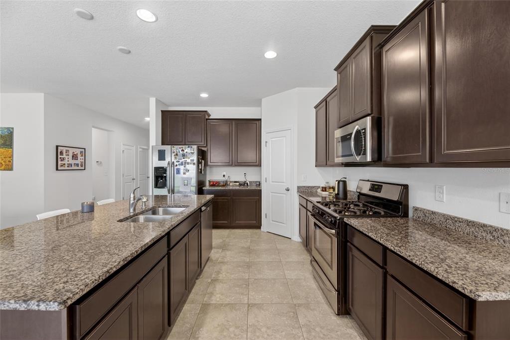 6309 Shadowlake Drive Apollo Beach, FL 33572 - Photo 14 of 64 a kitchen with granite countertop stainless steel appliances and sink