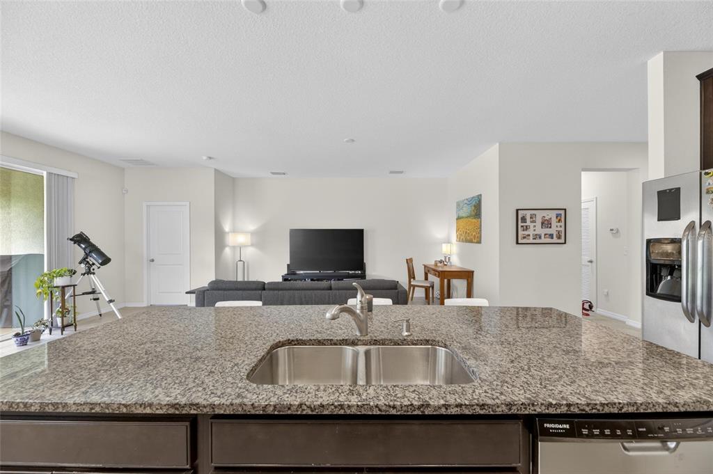 6309 Shadowlake Drive Apollo Beach, FL 33572 - Photo 16 of 64 a kitchen with granite countertop a sink and a granite counter tops