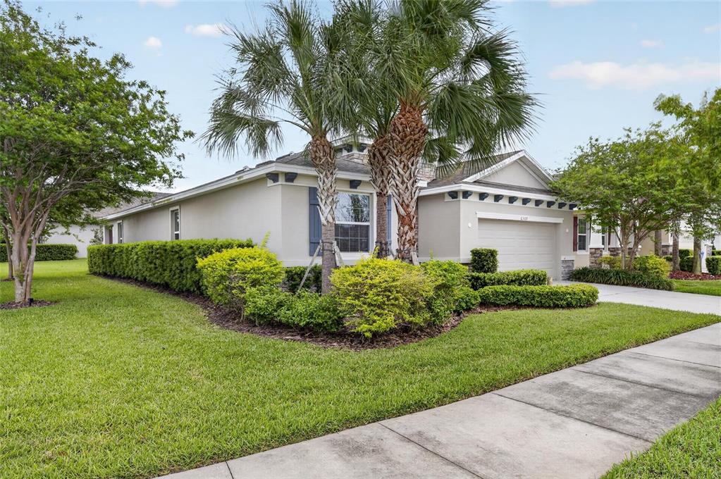 6309 Shadowlake Drive Apollo Beach, FL 33572 - Photo 2 of 64 a front view of a house with a garden and plants