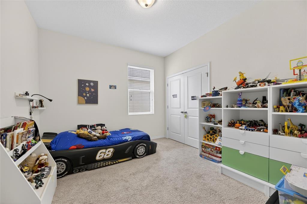 6309 Shadowlake Drive Apollo Beach, FL 33572 - Photo 29 of 64 a bedroom with furniture and a book shelf