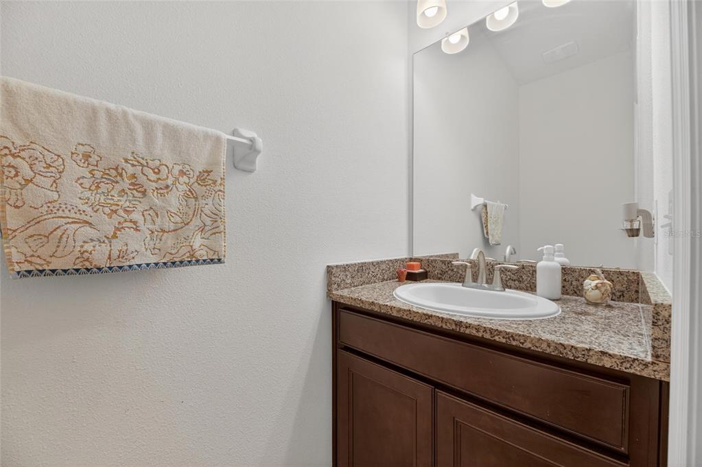 6309 Shadowlake Drive Apollo Beach, FL 33572 - Photo 30 of 64 a bathroom with a granite countertop sink and a mirror