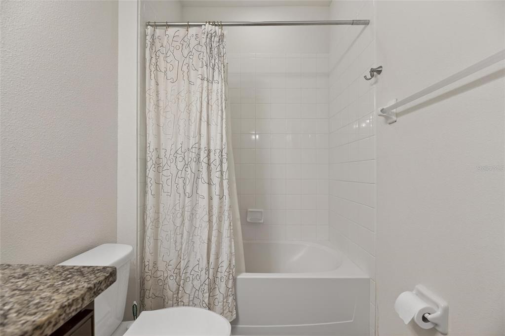 6309 Shadowlake Drive Apollo Beach, FL 33572 - Photo 31 of 64 a bathroom with a shower curtain and a toilet
