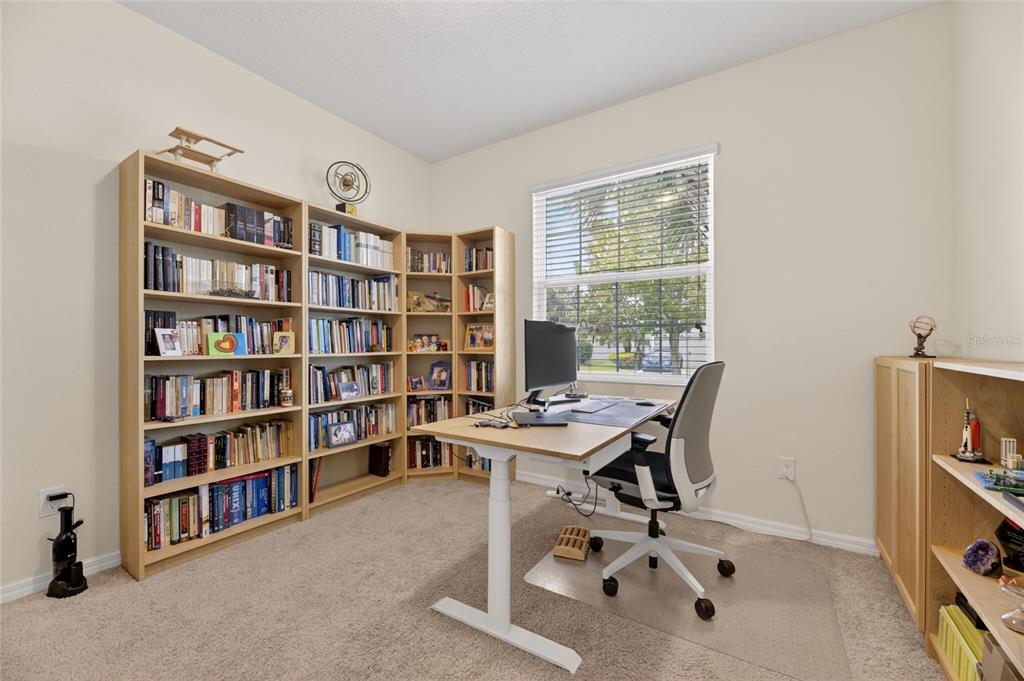 6309 Shadowlake Drive Apollo Beach, FL 33572 - Photo 36 of 64 a view of a workspace with furniture and a bookshelf