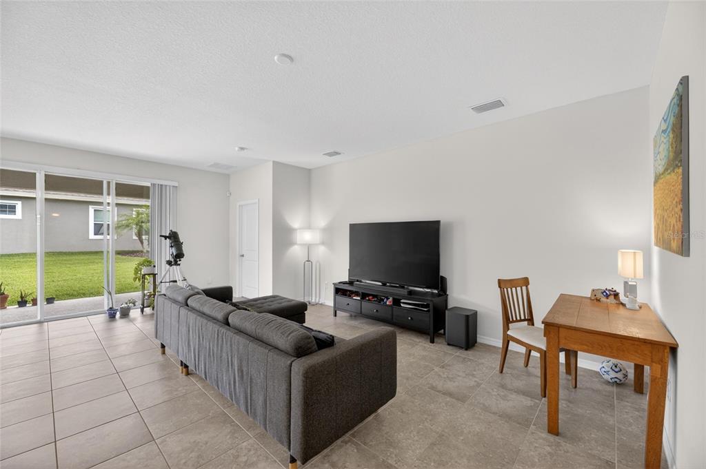 6309 Shadowlake Drive Apollo Beach, FL 33572 - Photo 4 of 64 a living room with furniture and a flat screen tv